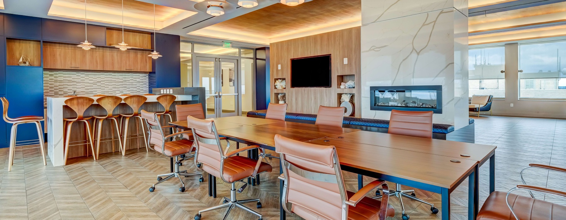 a spacious clubroom with a table and a tv