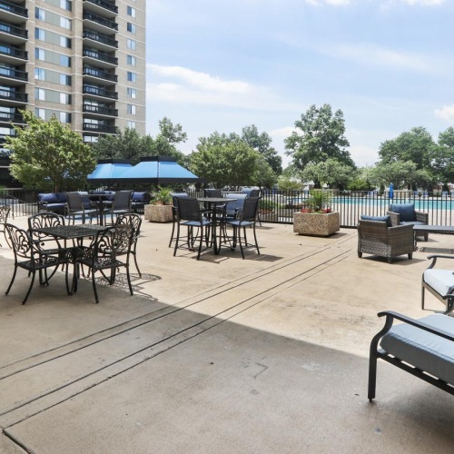 a patio with tables and chairs