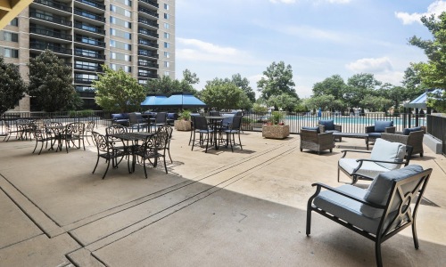 a patio with tables and chairs