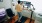 a person with a standing desk walking on a treadmill looking at multiple screens