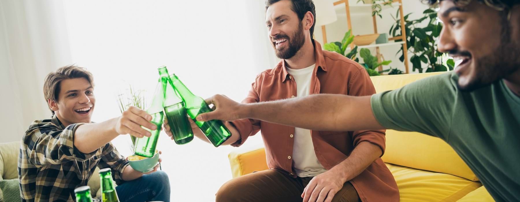 people with beer bottles in a living room